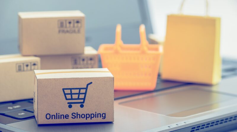 Shop online, ecommerce / retail commerce concept : Box or cartons with trolley or shopping cart, shopping basket on a laptop computer, depicts new lifestyle customers buy products via online store.