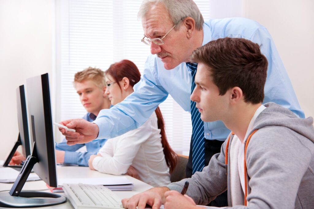 Group of students with a teacher in computer classroom